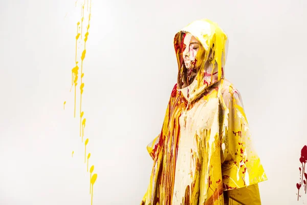 Beautiful Woman Raincoat Painted Yellow Red Paints Standing Hood Isolated — Free Stock Photo