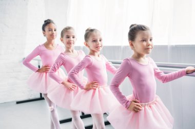 adorable little ballerinas practicing ballet in studio clipart