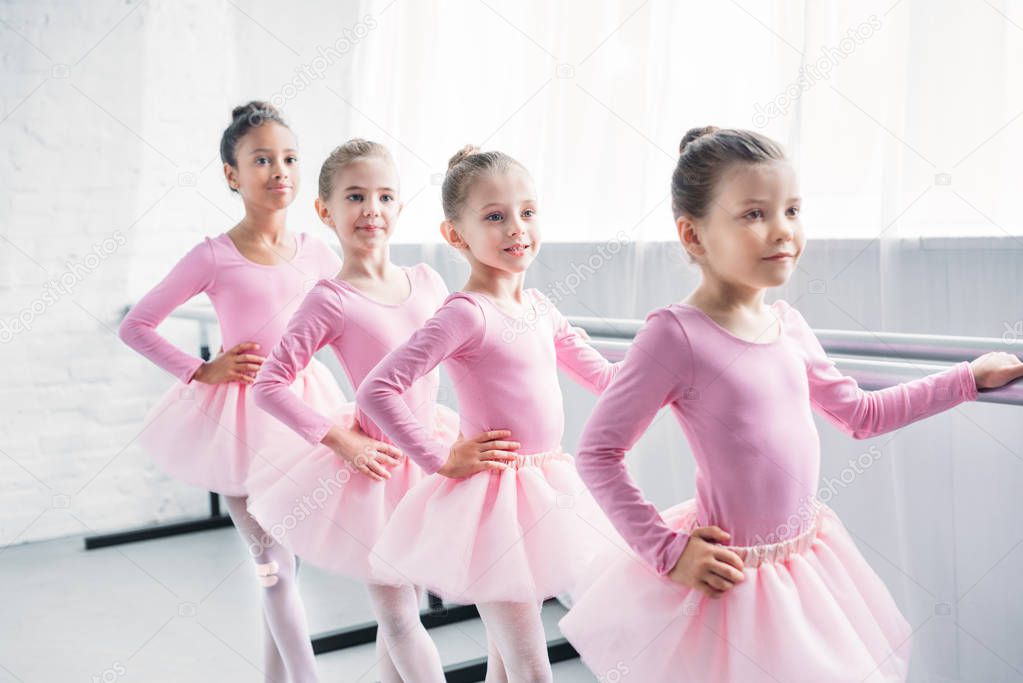 adorable little ballerinas practicing ballet in studio