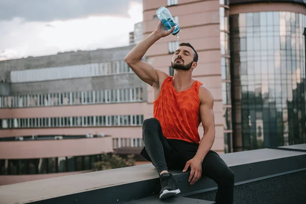 Handsome Sportsman Pouring Water Bottle Face Roof — Stock Photo, Image
