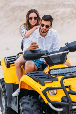 çölde Atv üzerinde otururken güzel genç çift alarak selfie
