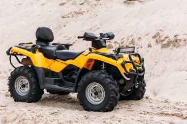 modern yellow all-terrain vehicle on sand clipart