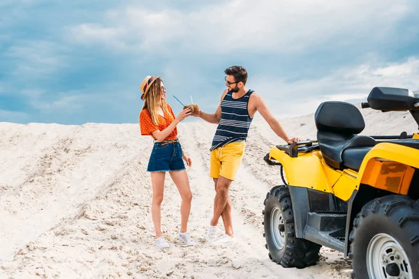 Relaxed Young Couple Atv Coconut Cocktails Desert — Stock Photo, Image