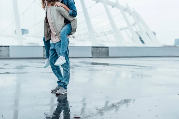 Cropped Shot Woman Piggybacking Boyfriends Back Parking Stadium — Free Stock Photo