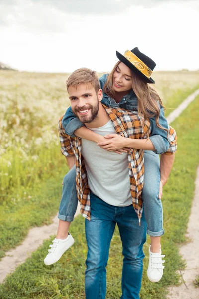 Happy Couple Piggybacking Together Summer Field Wild Flowers — Stock Photo, Image