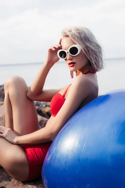 Girl Red Bikini Sunglasses Relaxing Blue Fitness Ball Rocky Beach — Stock Photo, Image