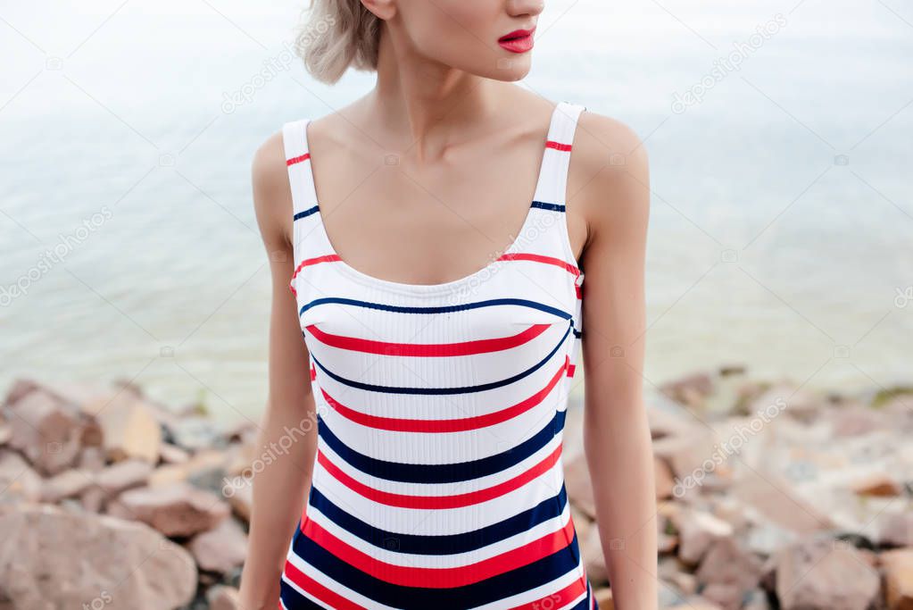 cropped view of woman in retro striped swimsuit