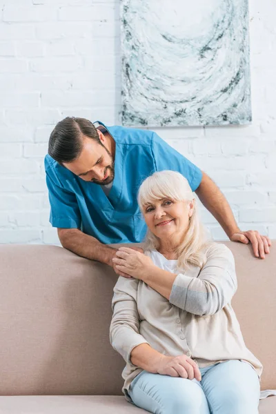 Happy Senior Woman Holding Hand Young Male Nurse Smiling Camera — Stock Photo, Image