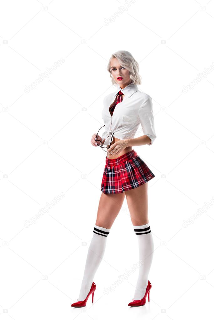 sexy young woman in short schoolgirl plaid skirt and knee socks with eyeglasses posing isolated on white
