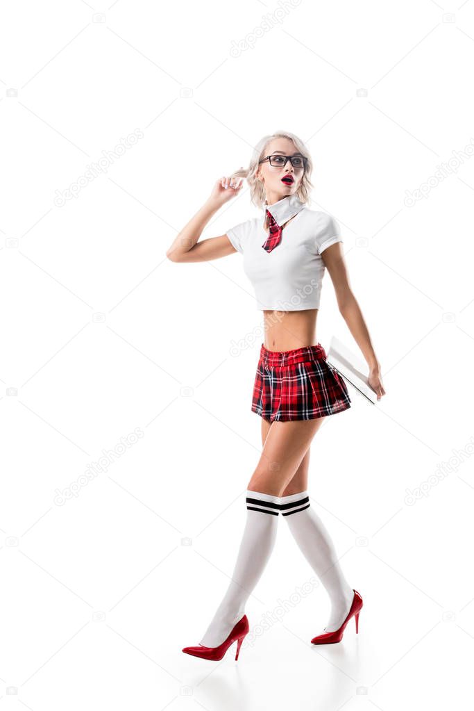 emotional woman in seductive schoolgirl uniform with laptop isolated on white
