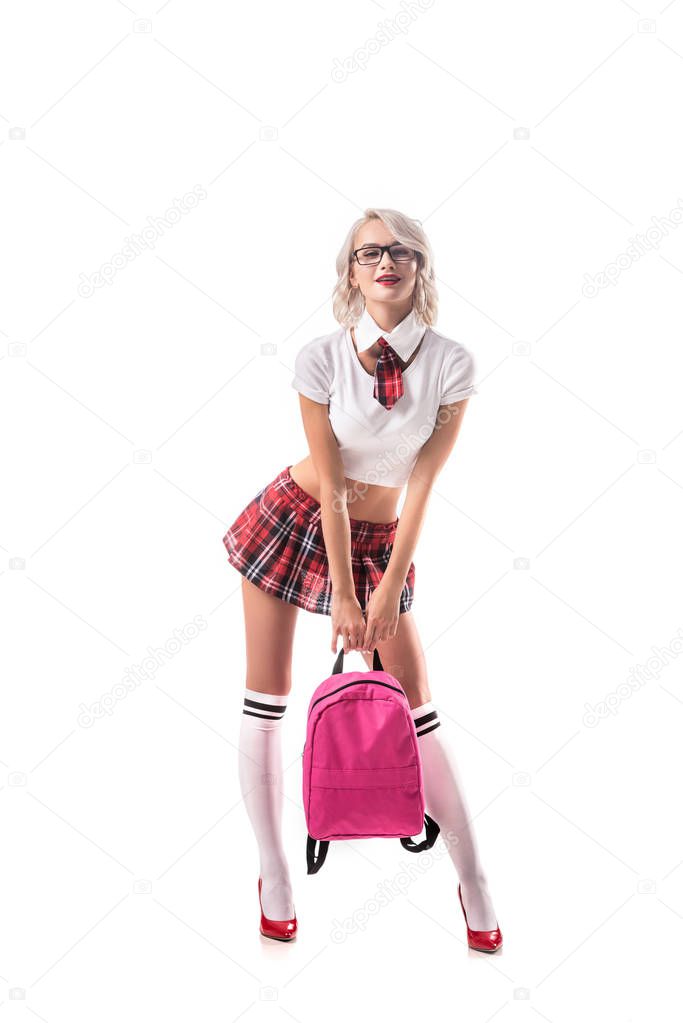 blond woman in seductive schoolgirl uniform with pink backpack isolated on white