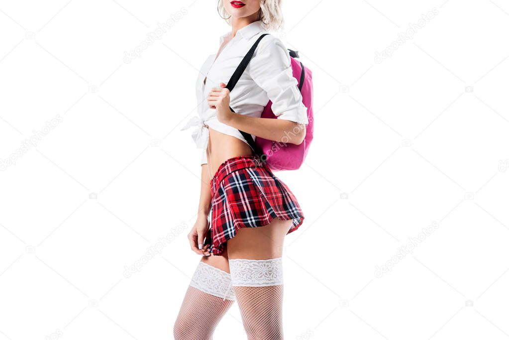 cropped shot of seductive woman in short schoolgirl skirt ad stockings with backpack isolated on white