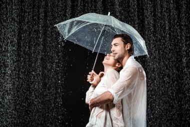 romantik çift beyaz gömlek siyah izole yağmur damlaları altında şemsiyesi altında ayakta yan görünüm