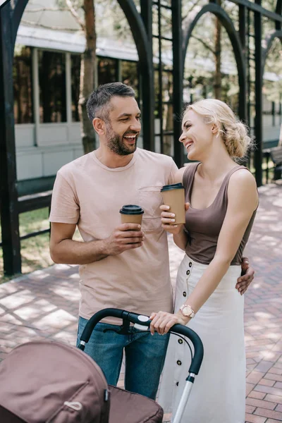 Laughing Parents Holding Coffee Baby Carriage Park — Stock Photo, Image