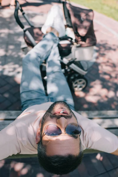 High Angle View Father Smoking Cigarette Bench Legs Baby Carriage — Free Stock Photo