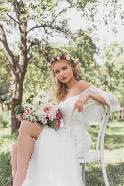 Beautiful Young Blonde Bride Sitting Chair Looking Camera Outdoors — Free Stock Photo