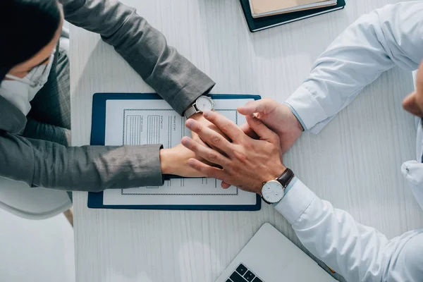 Overhead View Patient Doctor Holding Hands Insurance Claim Form Clinic — Stock Photo, Image