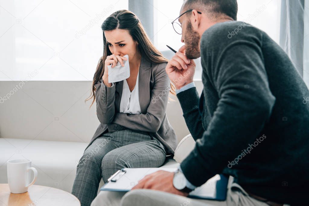 depressed patient crying in therapist office