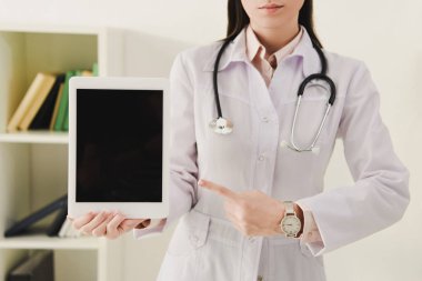 Doktor görünümünü dijital tablet boş ekran ile işaret stetoskop ile kırpılmış
