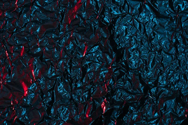 shiny abstract crumpled black foil background 