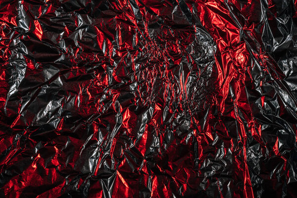 glittering abstract crumpled silver and red foil background 