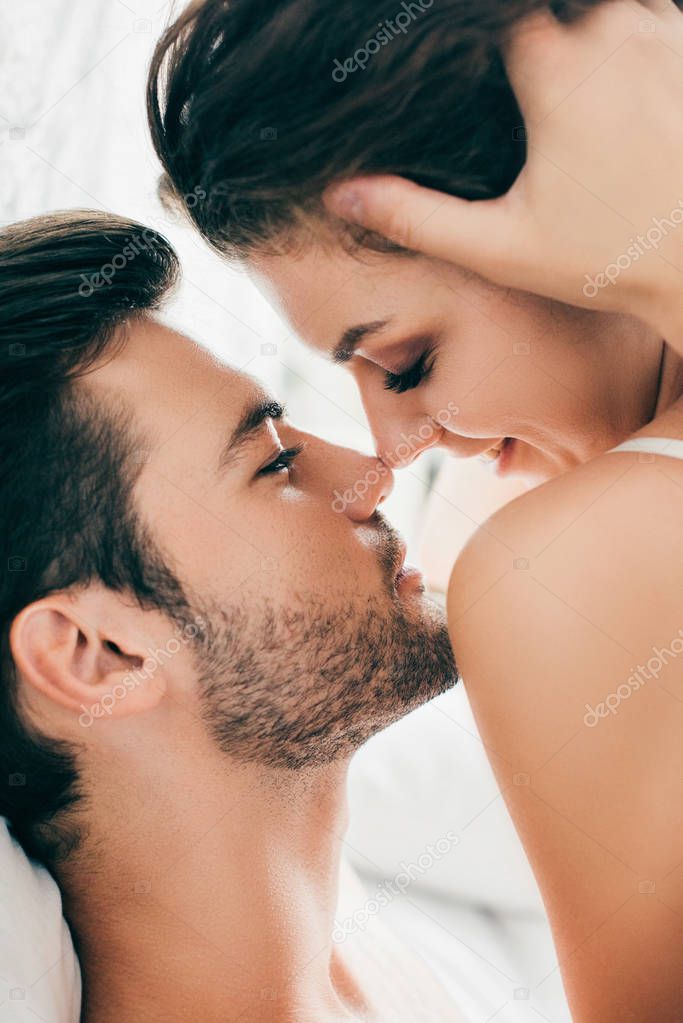 close-up view of sensual young couple able to kiss in foreplay  