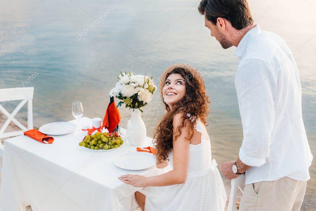 beautiful happy couple having romantic date on seashore