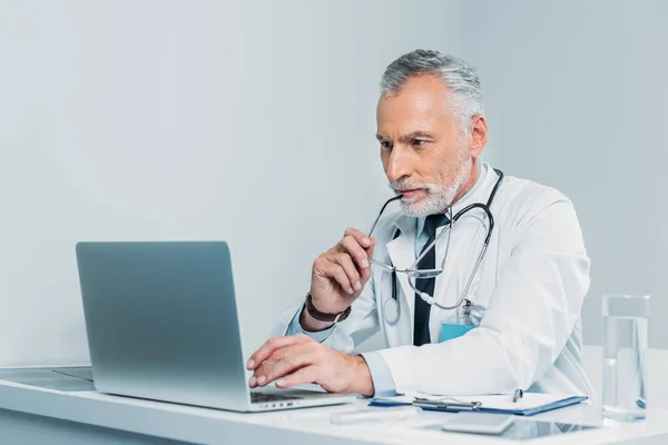 Middle Aged Male Doctor Holding Eyeglasses Using Laptop Table Office — Stock Photo, Image