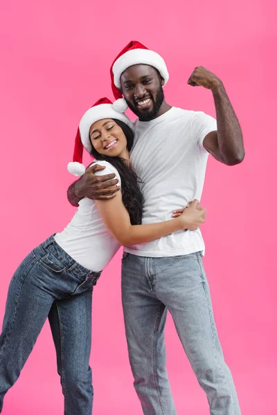 Attractive African American Woman Christmas Hat Embracing Boyfriend While Showing — Stock Photo, Image