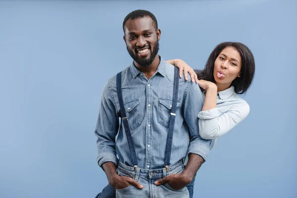 African American Girlfriend Hugging Boyfriend Sticking Tongue Out Isolated Blue — Stock Photo, Image