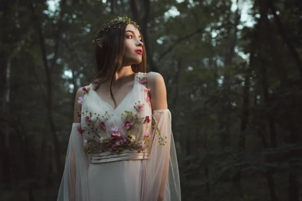 Attractive mystic elf in elegant dress with flowers in forest — Stock Image Attractive Mystic Elf Elegant Dress Flowers Forest Stock Photo