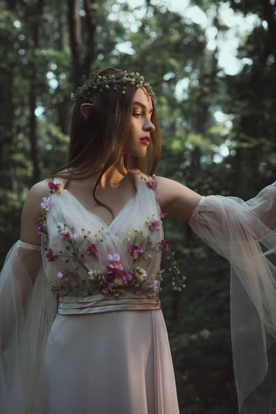 Mystic elf in floral wreath and dress with flowers in forest — Stock Image Mystic Elf Floral Wreath Dress Flowers Forest Stock Photo