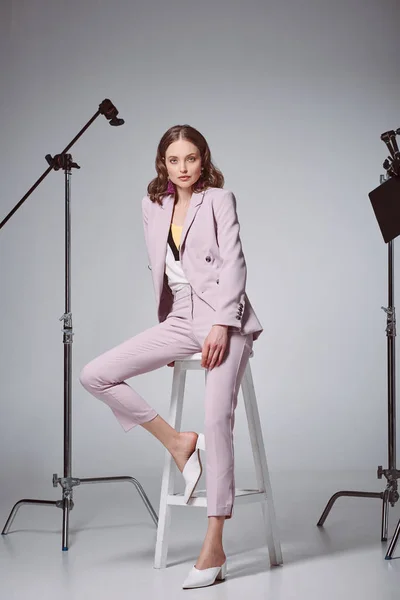 Fashionable Woman Sitting Stool Looking Camera Recording Studio — Free Stock Photo