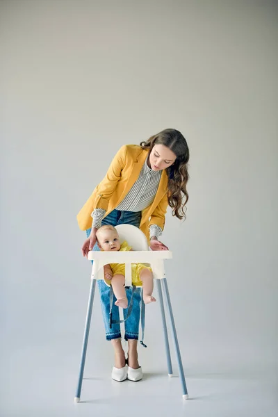 Fashionable Mother Looking Infant Sitting High Chair Grey — Stock Photo, Image