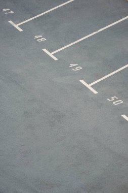 empty parking lots with numbers on grey asphalt clipart