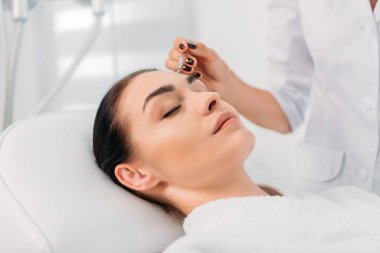 Güzel kadın spa merkezinde yüz temizleyici alma