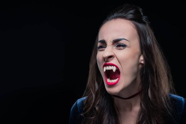 dreadful woman showing vampire teeth isolated on black clipart
