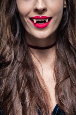 cropped view of woman showing vampire fangs clipart