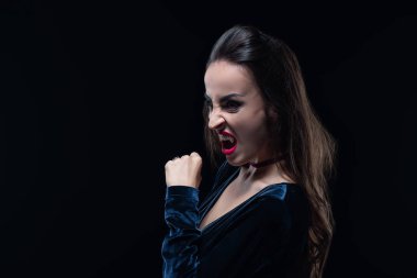dreadful woman showing vampire teeth isolated on black clipart
