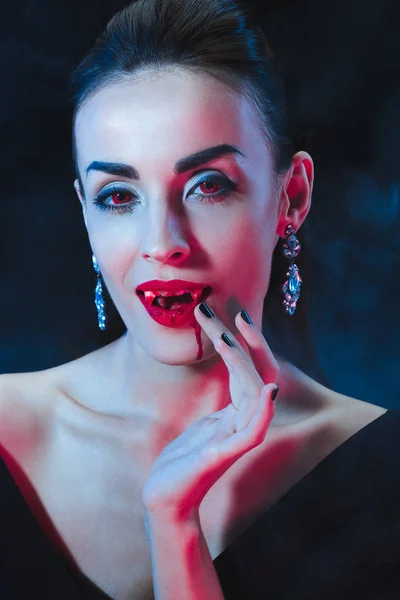 Sexy Vampire Woman Licking Her Fingers Dark Background Smoke — Free Stock Photo