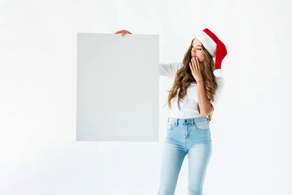 Shocked Girl Santa Hat Looking Blank Placard Isolated White — Free Stock Photo