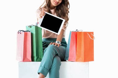 bir kız ile alışveriş torbaları dijital tablet üzerinde beyaz izole boş ekran ile gösterilen kırpılmış görünümü