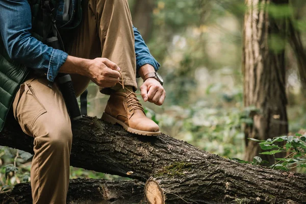 Partial View Man Tying Shoelaces Log While Hiking Forest Alone — Stock Photo, Image