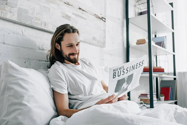 Smiling Bearded Businessman Long Hair Reading Newspaper Bed Morning Time — Free Stock Photo