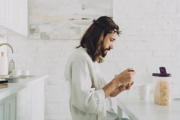 Vista Lateral Jesús Comiendo Hojuelas Maíz Desayuno Cocina Casa — Foto de stock gratis