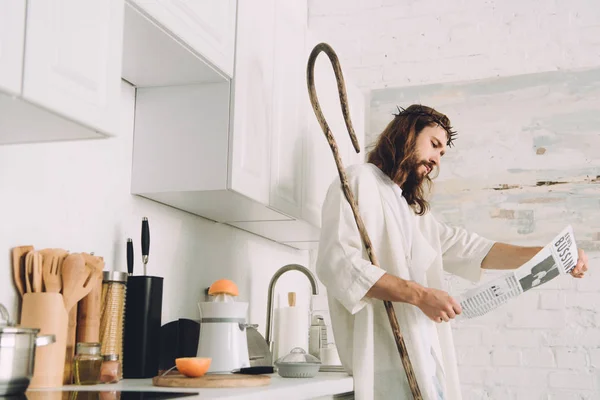 Selective Focus Jesus Wooden Staff Reading Business Newspaper Kitchen Home — Free Stock Photo