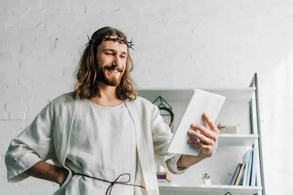 Jésus Souriant Couronne Épines Robe Aide Une Tablette Numérique Maison — Photo gratuite