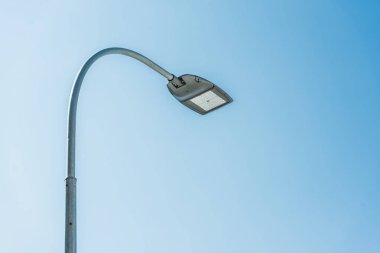 low angle view of street lamp against blue sky clipart