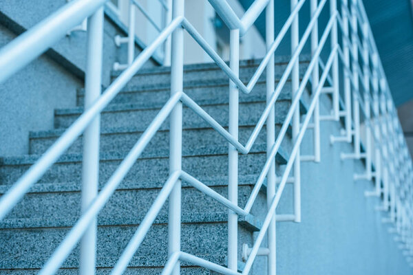 low angle view of grey stairs with white railings