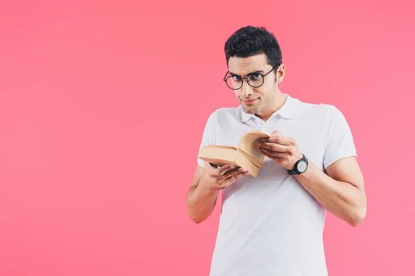 Handsome Skeptical Student Holding Books Looking Camera Isolated Pink — Stock Photo, Image